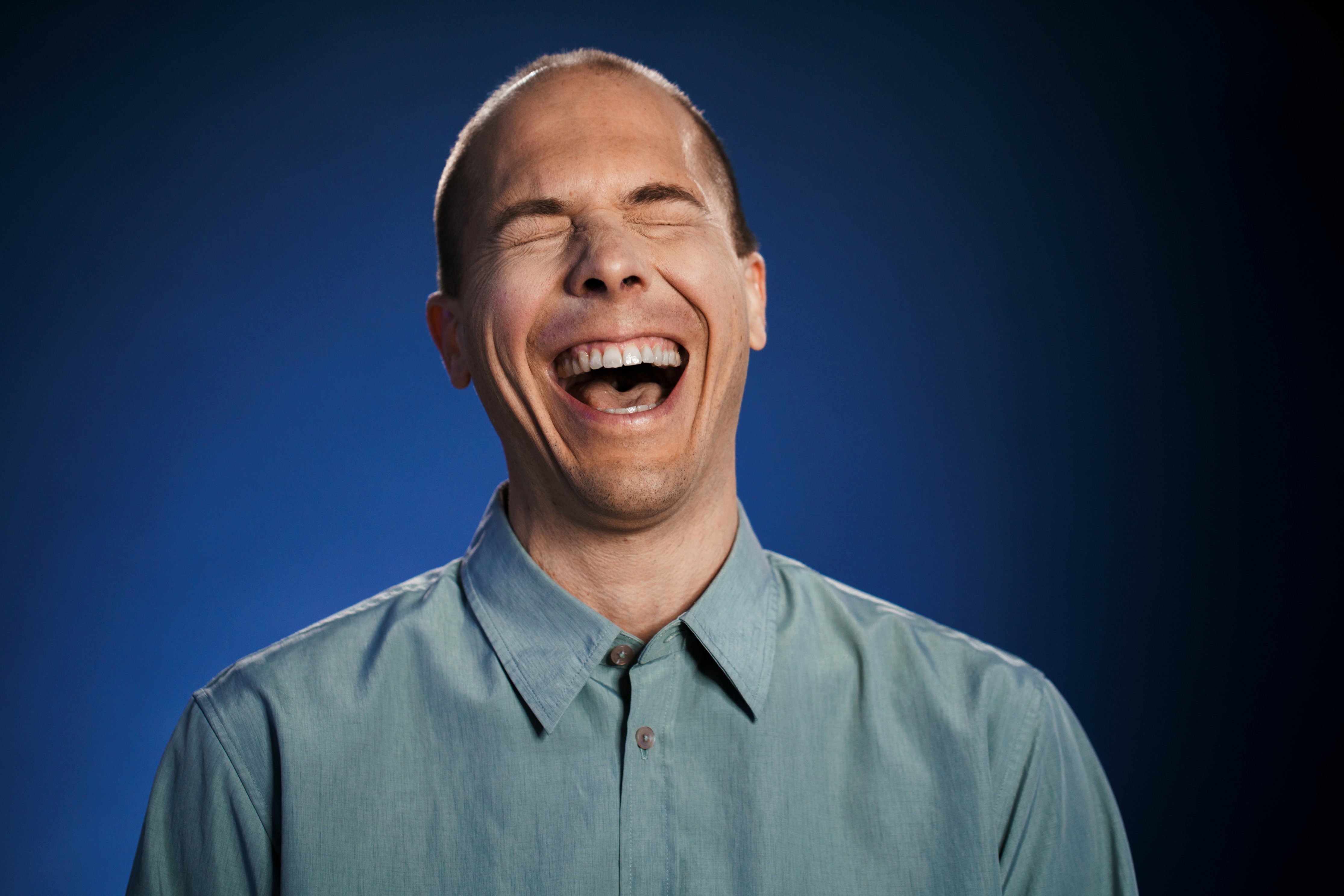 man laughing in living room